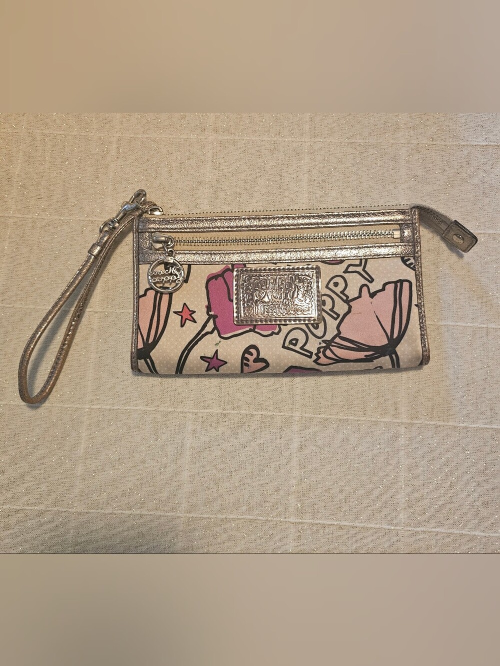 Coach Poppy pink floral graffiti print and metallic silver trim wristlet